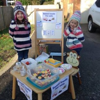 Annabel and Jessica fundraising with their Cake stand