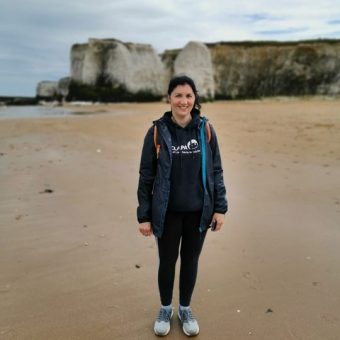 Jenny on beach in CLAPA hoodie