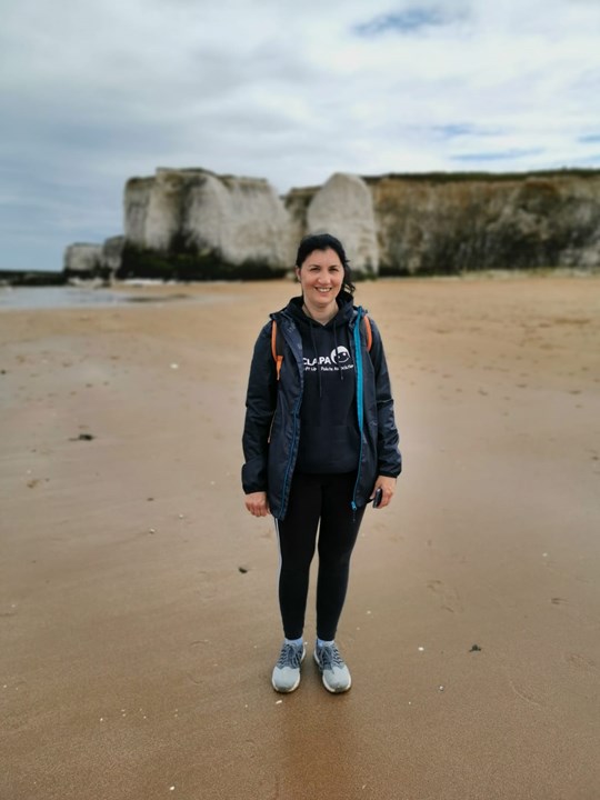 Jenny on beach in CLAPA hoodie