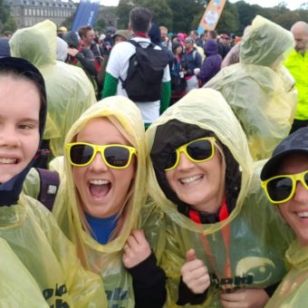 Fundraisers at Kiltwalk wearing yellow poncos.