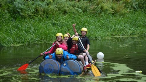 Children on a lake in a raft
