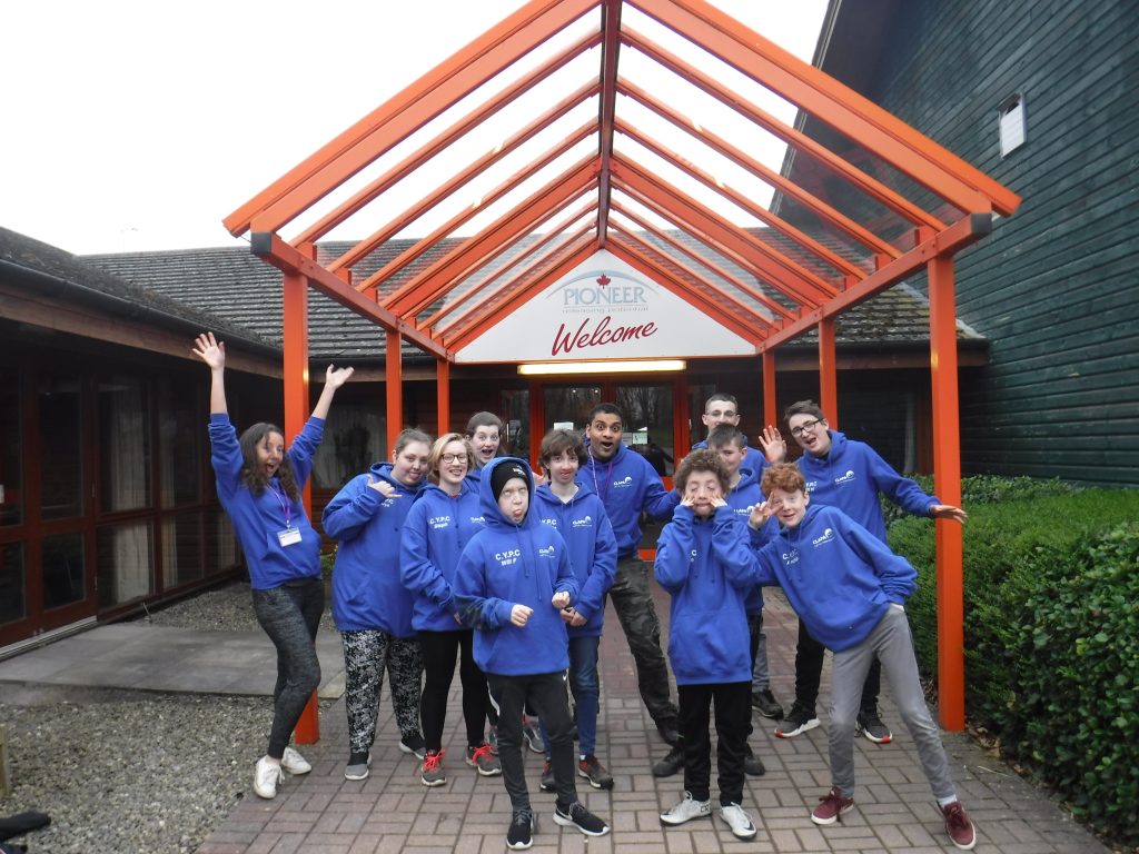 A group of young people wearing blue jumpers