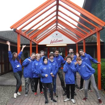 A group of young people wearing blue jumpers