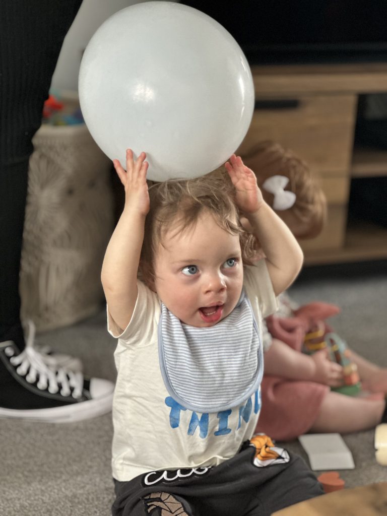Theo holding a balloon