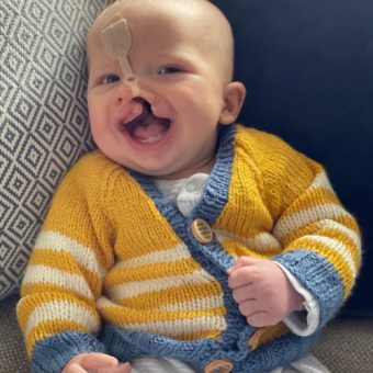 Grandson Joshua in knitted yellow cardigan and smiling face