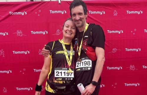 Jodie and Paul with medals and running numbers
